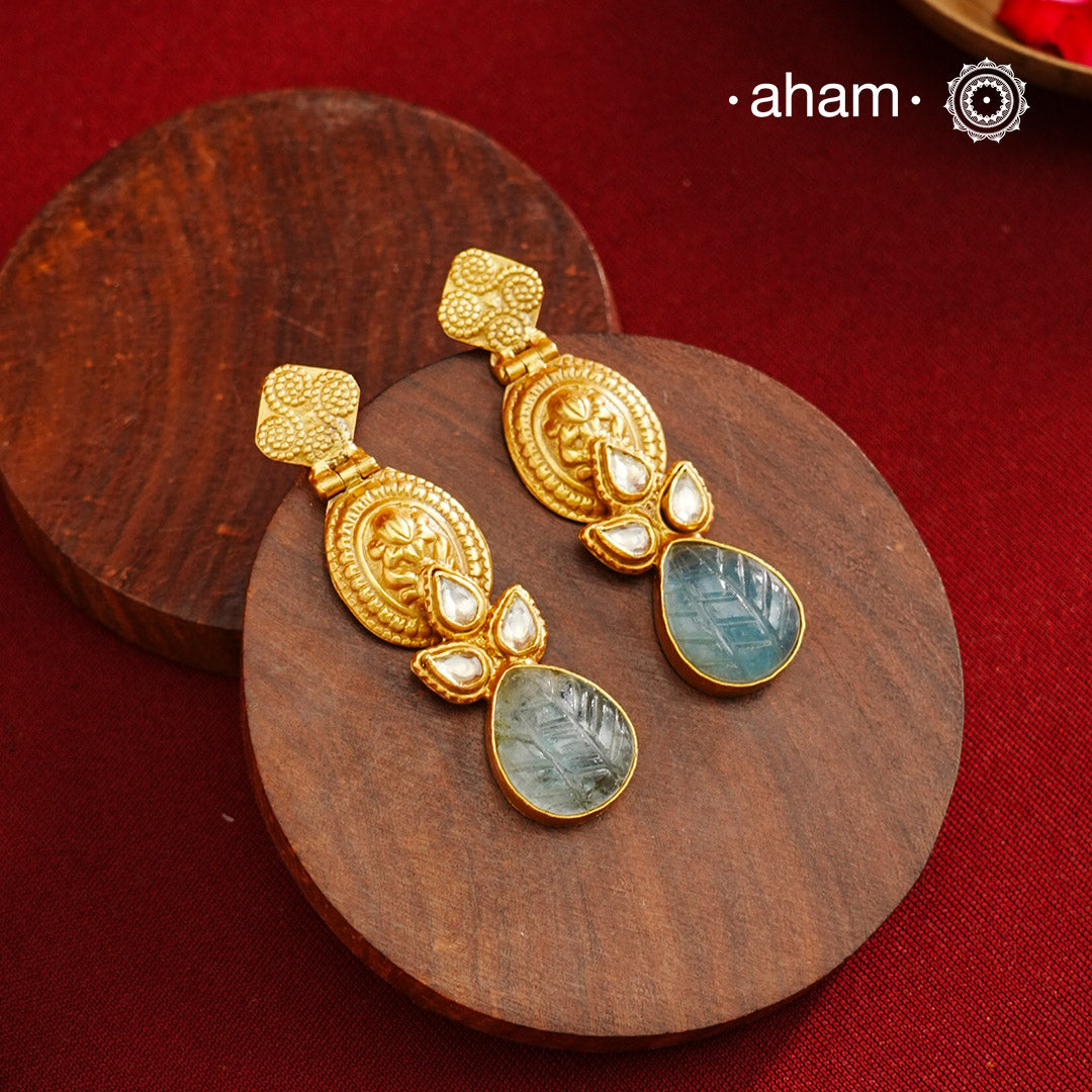 Statement gold polish earring with beautiful stone drop and kundan work.Handcrafted using traditional methods in 92.5 sterling silver with gold polish.Pair these with your ethnic outfits this festive season to ace your look.