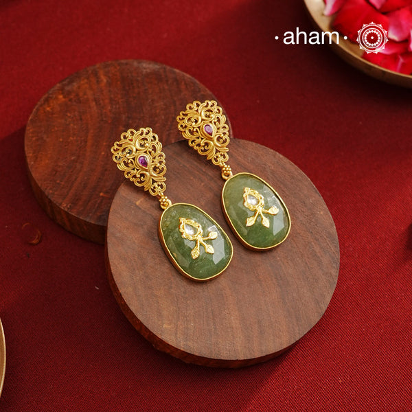 These Gold Polish Silver Earrings feature exquisite lattice-like detailing with a striking kemp stone centerpiece and a serene green drop stone accented by intricate inlay work. Crafted from 92.5% silver and finished with a luxurious gold polish, they seamlessly combine contemporary design with timeless traditional elegance.