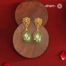 These Gold Polish Silver Earrings feature exquisite lattice-like detailing with a striking kemp stone centerpiece and a serene green drop stone accented by intricate inlay work. Crafted from 92.5% silver and finished with a luxurious gold polish, they seamlessly combine contemporary design with timeless traditional elegance.