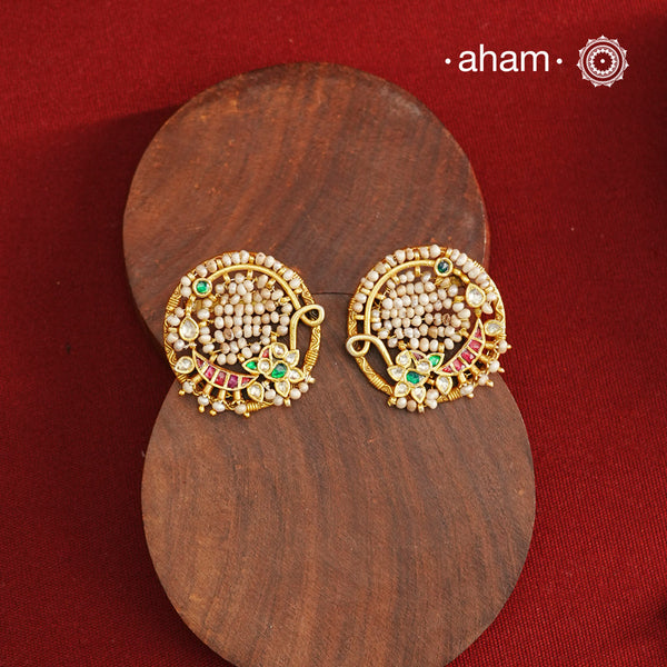 These Nath-inspired silver studs feature intricate kundan and pearl detailing, finished with a rich gold polish. Crafted from 92.5% pure silver, they blend traditional elegance with durability, making them an ideal accessory for festive occasions. Their refined design complements ethnic attire, adding a touch of sophistication to your celebration ensemble.