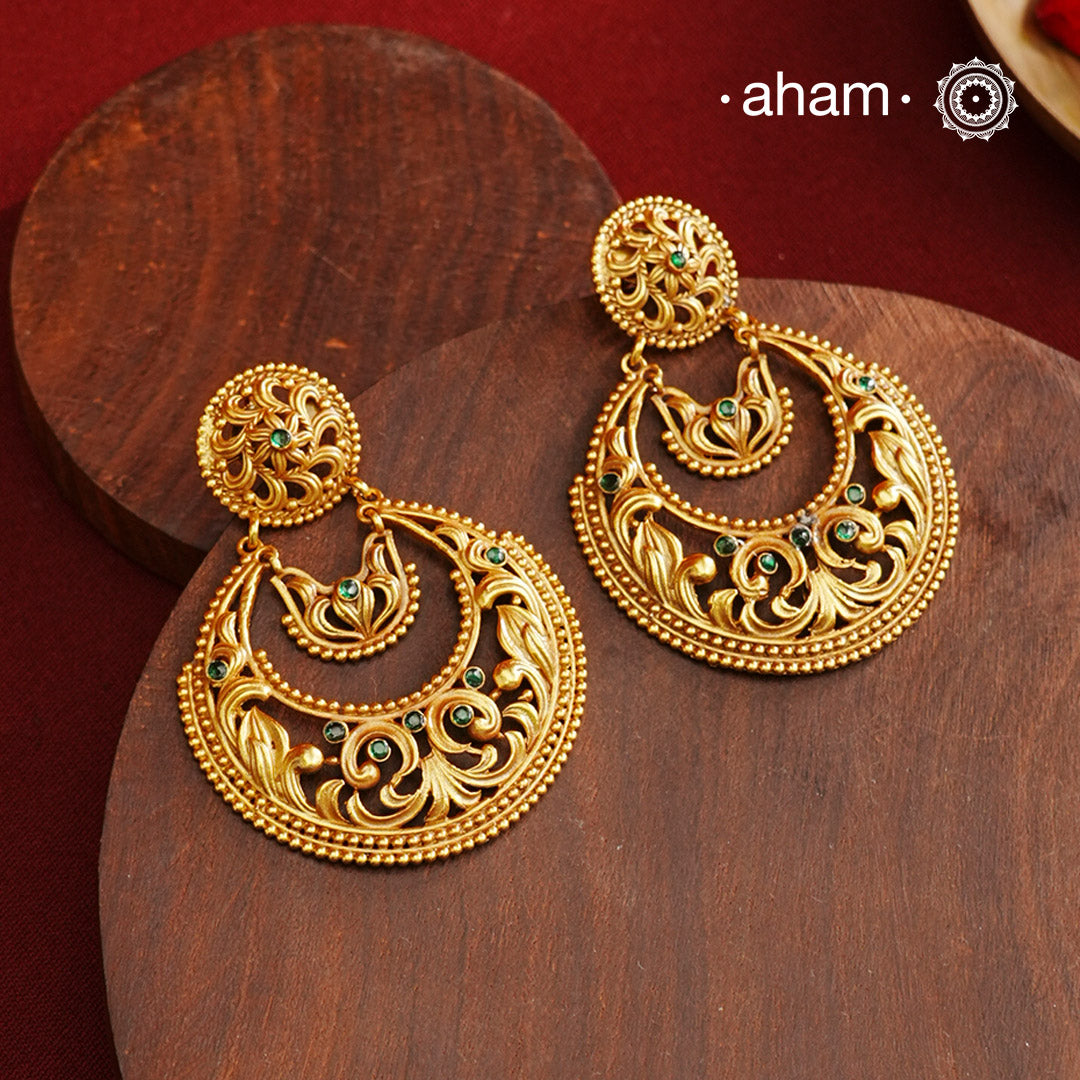 These Gold Polish Silver Chandbali Earrings showcase intricate rava and filigree craftsmanship, reflecting timeless traditional design. Crafted from 92.5% sterling silver with a delicate gold polish, they offer enduring elegance suitable for generations. Their classic style ensures they remain a fashionable choice for any occasion.