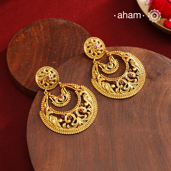 These Gold Polish Silver Chandbali Earrings showcase intricate rava and filigree craftsmanship, reflecting timeless traditional design. Crafted from 92.5% sterling silver with a delicate gold polish, they offer enduring elegance suitable for generations. Their classic style ensures they remain a fashionable choice for any occasion.