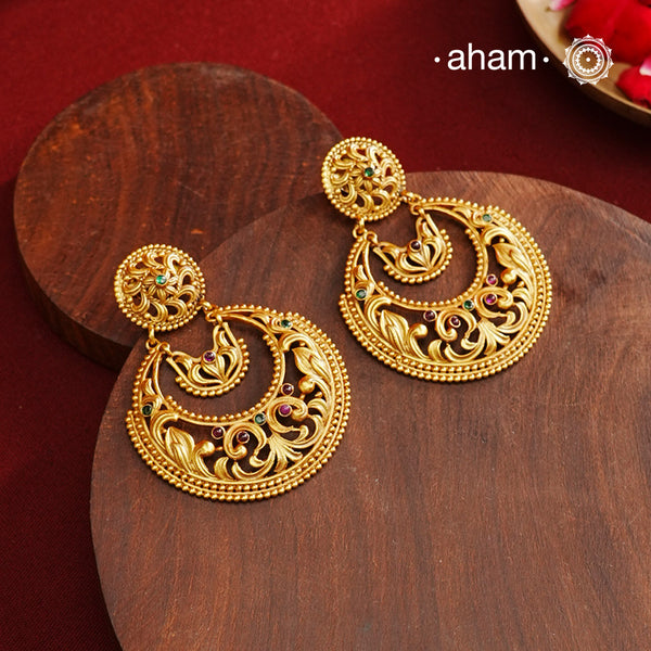 These Gold Polish Silver Chandbali Earrings showcase intricate rava and filigree craftsmanship, reflecting timeless traditional design. Crafted from 92.5% sterling silver with a delicate gold polish, they offer enduring elegance suitable for generations. Their classic style ensures they remain a fashionable choice for any occasion.