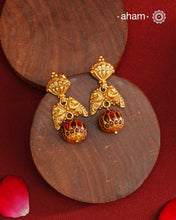 These Gold Polish Peacock Silver Earrings beautifully reflect the elegance of South Indian traditional design, featuring delicate kemp work. Crafted from 92.5% pure silver with a fine gold polish, it is a graceful and timeless design that complements your style effortlessly.