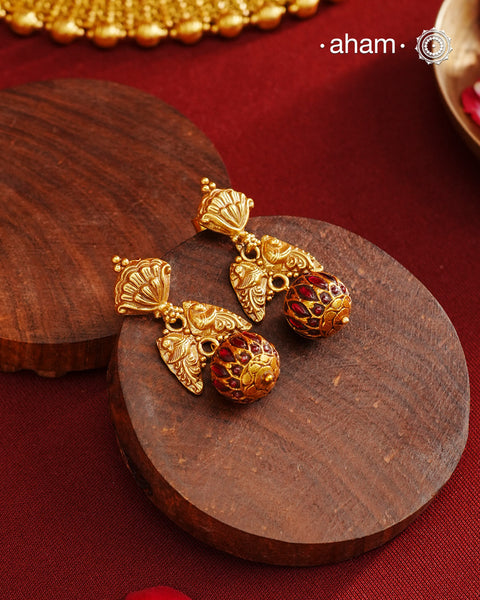 These Gold Polish Peacock Silver Earrings beautifully reflect the elegance of South Indian traditional design, featuring delicate kemp work. Crafted from 92.5% pure silver with a fine gold polish, it is a graceful and timeless design that complements your style effortlessly.