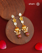 These Gold Polish Peacock Silver Earrings beautifully reflect the elegance of South Indian traditional design, featuring delicate kemp and pearl work along with some kundan highlights. Crafted from 92.5% pure silver with a fine gold polish, it is a graceful and timeless design that complements your style effortlessly.