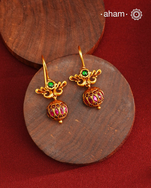 These Gold Polish Peacock Silver Earrings beautifully reflect the elegance of South Indian traditional design, featuring delicate kemp work. Crafted from 92.5% pure silver with a fine gold polish, it is a graceful and timeless design that complements your style effortlessly.