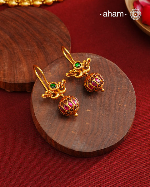 These Gold Polish Peacock Silver Earrings beautifully reflect the elegance of South Indian traditional design, featuring delicate kemp work. Crafted from 92.5% pure silver with a fine gold polish, it is a graceful and timeless design that complements your style effortlessly.