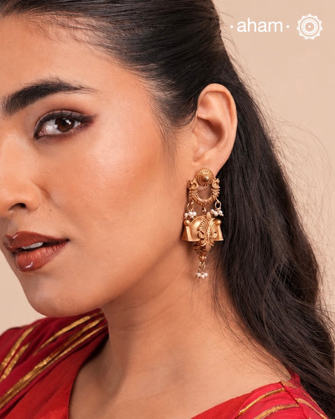 Statement gold polish earring with beautiful designs inspired from the temples of South India and traditional south indian jewellery motifs. Handcrafted using traditional methods in 92.5 sterling silver with dull gold polish. Pair these with your ethnic outfits this festive season to ace your look.