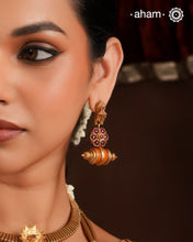 Statement gold polish earring with beautiful coral drop and kemp setting.
Handcrafted using traditional methods in 92.5 sterling silver with gold polish.&nbsp;
Pair these with your ethnic outfits this festive season to ace your look.