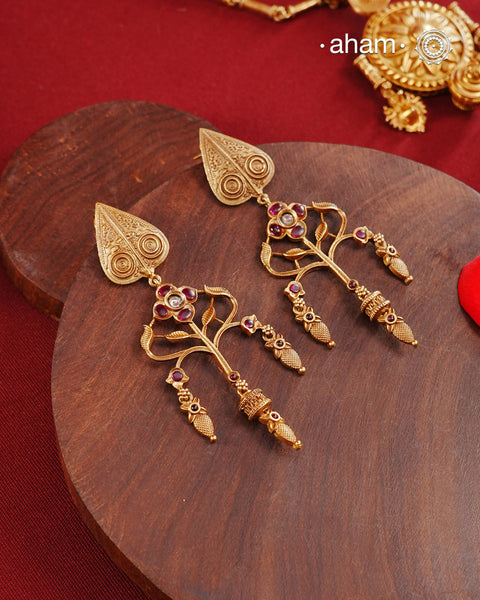 Statement gold polish earring with beautiful designs inspired from the temples of South India. Handcrafted using traditional methods in 92.5 sterling silver with dull gold polish.Pair these with your ethnic outfits this festive season to ace your look.