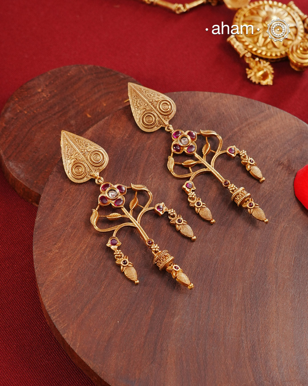 Statement gold polish earring with beautiful designs inspired from the temples of South India. Handcrafted using traditional methods in 92.5 sterling silver with dull gold polish.Pair these with your ethnic outfits this festive season to ace your look.