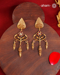 Statement gold polish earring with beautiful designs inspired from the temples of South India. Handcrafted using traditional methods in 92.5 sterling silver with dull gold polish.Pair these with your ethnic outfits this festive season to ace your look.