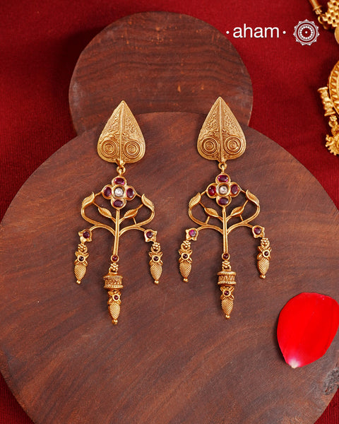 Statement gold polish earring with beautiful designs inspired from the temples of South India. Handcrafted using traditional methods in 92.5 sterling silver with dull gold polish.Pair these with your ethnic outfits this festive season to ace your look.