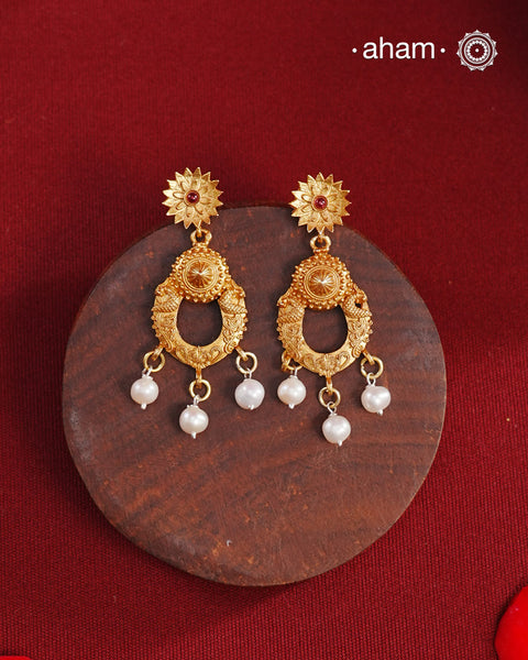 Statement gold polish earring with beautiful designs inspired from the temples of South India. Handcrafted using traditional methods in 92.5 sterling silver with dull gold polish. Pair these with your ethnic outfits this festive season to ace your look.