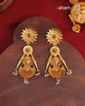 Statement gold polish earring with beautiful designs inspired from the temples of South India. Handcrafted using traditional methods in 92.5 sterling silver with dull gold polish. Pair these with your ethnic outfits this festive season to ace your look.