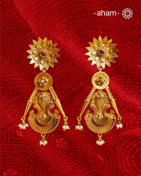 Statement gold polish earring with beautiful designs inspired from the temples of South India. Handcrafted using traditional methods in 92.5 sterling silver with dull gold polish.&nbsp;