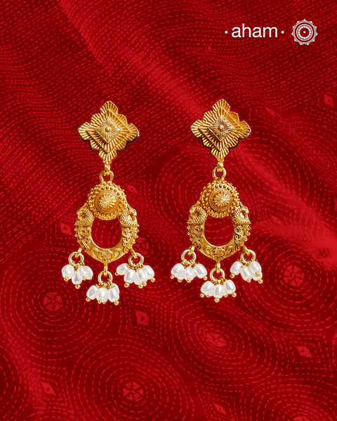 Statement gold polish earring with beautiful designs inspired from the temples of South India. Handcrafted using traditional methods in 92.5 sterling silver with dull gold polish. Pair these with your ethnic outfits this festive season to ace your look.