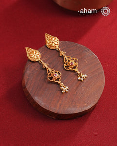 Statement gold polish earring with beautiful designs inspired from the temples of South India. Handcrafted using traditional methods in 92.5 sterling silver with dull gold polish. Pair these with your ethnic outfits this festive season to ace your look.