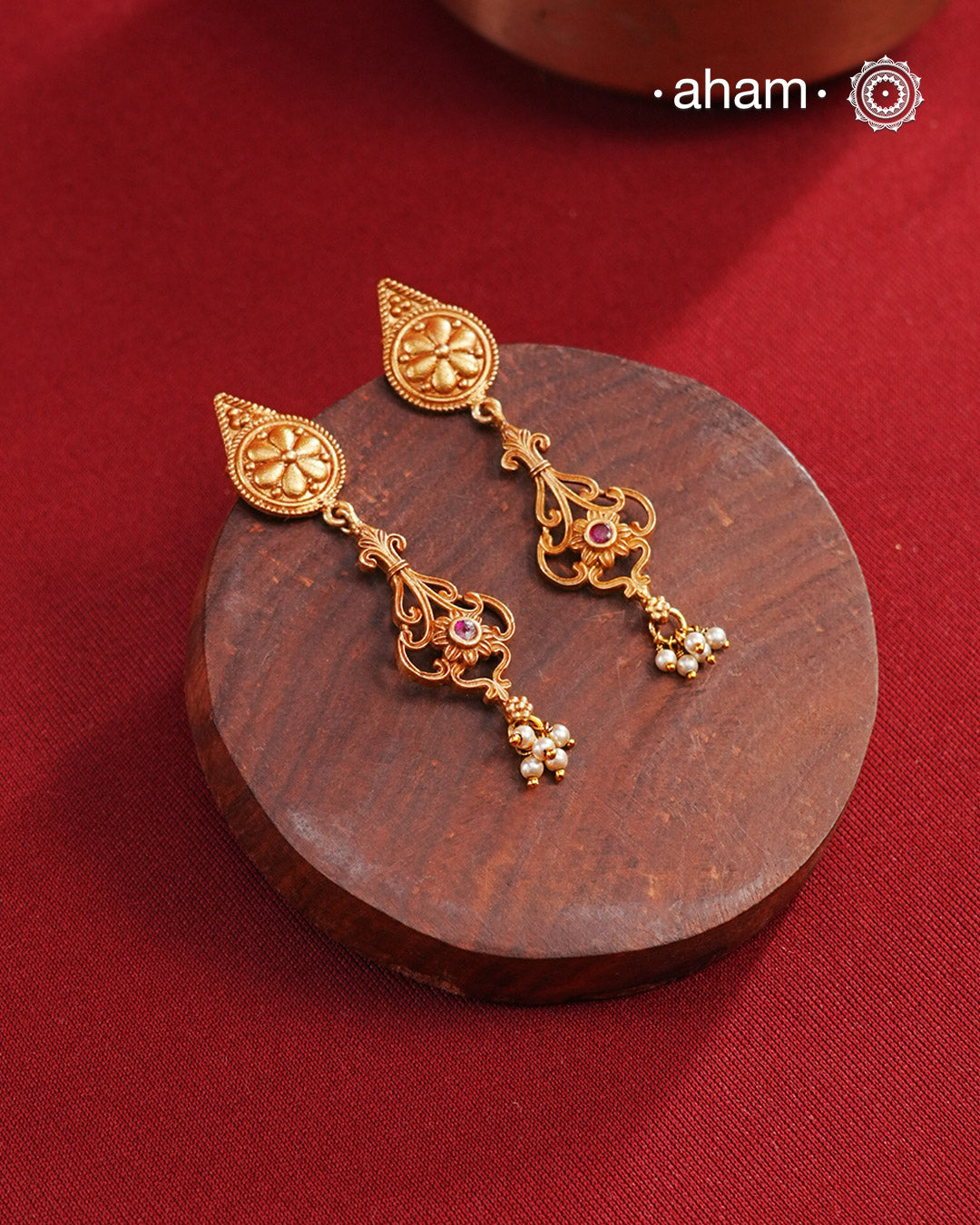 Statement gold polish earring with beautiful designs inspired from the temples of South India. Handcrafted using traditional methods in 92.5 sterling silver with dull gold polish. Pair these with your ethnic outfits this festive season to ace your look.