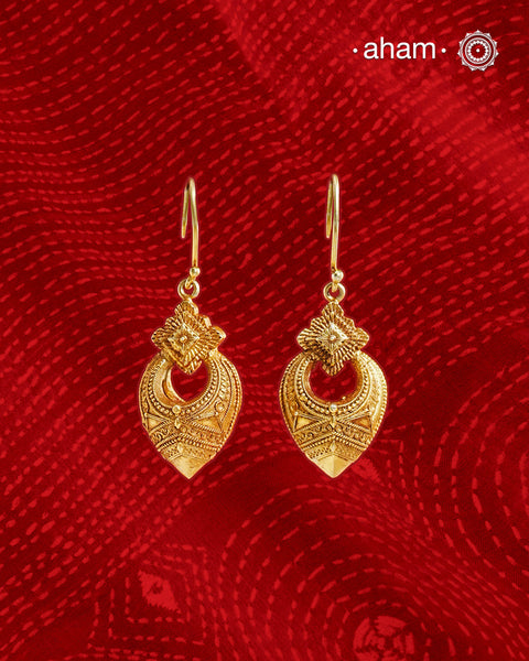 Statement gold polish earring with beautiful designs inspired from the temples of South India. Handcrafted using traditional methods in 92.5 sterling silver with dull gold polish.