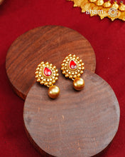 Traditional Gold Polish earrings with a kemp Center.Handcrafted using traditional methods in 92.5 sterling silver with gold polish.Perfect to Pair these with your ethnic outfits this festive season.