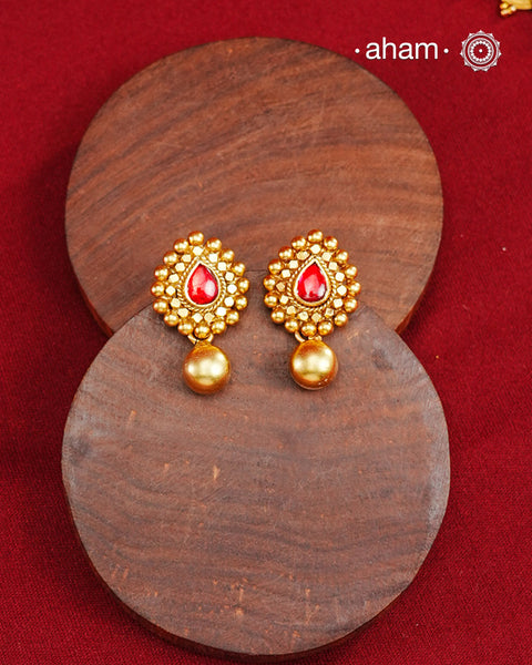 Traditional Gold Polish earrings with a kemp Center.Handcrafted using traditional methods in 92.5 sterling silver with gold polish.Perfect to Pair these with your ethnic outfits this festive season.