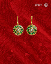 These two-sided hoop earrings combine classic elegance with contemporary design. Made from 92.5% silver and finished with a fine gold polish, they showcase red kundan stones on one side and green kundan on the other. This dual-sided feature offers versatile styling options, complementing a wide range of Indian attire. Expertly crafted, these earrings deliver both quality and adaptability for sophisticated everyday or festive wear.