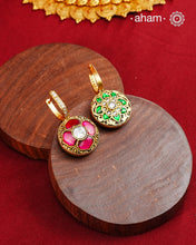 These two-sided hoop earrings combine classic elegance with contemporary design. Made from 92.5% silver and finished with a fine gold polish, they showcase red kundan stones on one side and green kundan on the other. This dual-sided feature offers versatile styling options, complementing a wide range of Indian attire. Expertly crafted, these earrings deliver both quality and adaptability for sophisticated everyday or festive wear.
