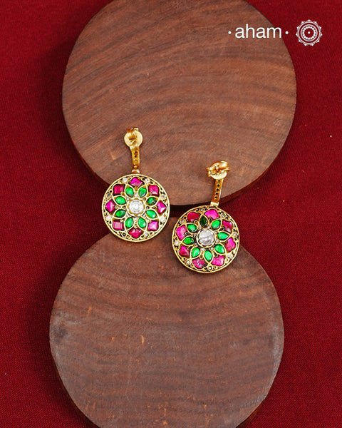 Half hoop pattern&nbsp;Made from 92.5% silver and finished with a fine gold polish, they showcase red kundan stones on one side and red &amp;&nbsp; green kundan on the back side. Expertly crafted, these earrings deliver both quality and adaptability for sophisticated everyday or festive wear.