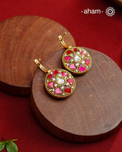 These&nbsp; hoop inspired earrings combine classic elegance with contemporary design. Made from 92.5% silver and finished with a fine gold polish, they showcase greenkundan stones on one side and red kundan on the back. Expertly crafted, these earrings deliver both quality and adaptability for most Indian attires.