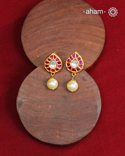 Traditional Gold Polish Studs with a kemp work and pearl drop.  
Handcrafted using traditional methods in 92.5 sterling silver with gold polish. 
Perfect to Pair these with your ethnic outfits this festive season. 