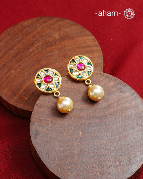 Traditional Gold Polish Studs with a kundan work and pearl drop.
Handcrafted using traditional methods in 92.5 sterling silver with gold polish. 
Perfect to Pair these with your ethnic outfits this festive season. 