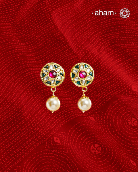 Traditional Gold Polish Studs with a kundan work and pearl drop.
Handcrafted using traditional methods in 92.5 sterling silver with gold polish.&nbsp;
Perfect to Pair these with your ethnic outfits this festive season.
