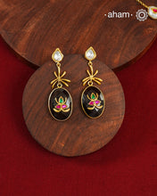 These Black Onyx Gold Polish Silver Earrings feature exquisite kundan inlay work, blending traditional craftsmanship with contemporary style. Perfectly suited for Indo-Western ensembles, they add a touch of elegance and sophistication to your look. Crafted with attention to detail, these earrings enhance your outfit with their rich black onyx contrast and subtle gold polish, making them a versatile accessory for special occasions.