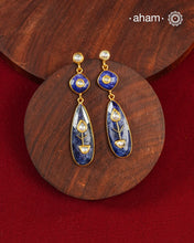 These Lapiz Gold Polish Silver Earrings feature exquisite kundan inlay work, blending traditional craftsmanship with contemporary style. Perfectly suited for Indo-Western ensembles, they add a touch of elegance and sophistication to your look. Crafted with attention to detail, these earrings enhance your outfit with their deep blue contrast and subtle gold polish, making them a versatile accessory for special occasions.