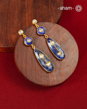 These Lapiz Gold Polish Silver Earrings feature exquisite kundan inlay work, blending traditional craftsmanship with contemporary style. Perfectly suited for Indo-Western ensembles, they add a touch of elegance and sophistication to your look. Crafted with attention to detail, these earrings enhance your outfit with their deep blue contrast and subtle gold polish, making them a versatile accessory for special occasions.