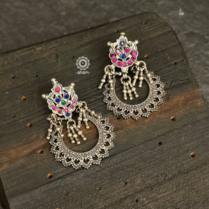 Expertly crafted from tribal silver with intricate detailing, these Chandbali earrings are a statement piece. Featuring stunning stone highlights, each earring has its own unique colour combination. Elevate any outfit with these one-of-a-kind earrings.