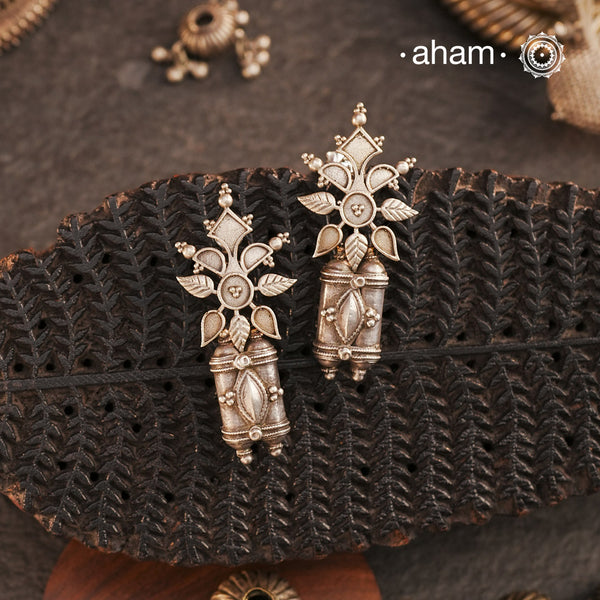 An exquisite fusion of old and new, these Tribal Amulet Silver Earrings showcase vintage tribal amulets paired with a delicately crafted floral motif. This unique combination reflects the artistry of traditional silversmithing while embracing contemporary design. Made in silver, these earrings are perfect for adding an ethnic yet versatile touch to your collection