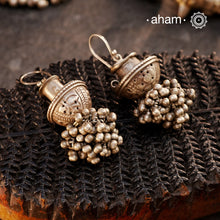 A captivating design rooted in tradition, these Tribal Silver Earrings reimagines an earplug as a jhumka, adding a cascade of ghungroos at the bottom for a playful, rhythmic touch. We have added a fishhook at the top, making them easy to wear. Handcrafted in silver, these earrings offer a beautiful blend of tribal history and contemporary elegance.