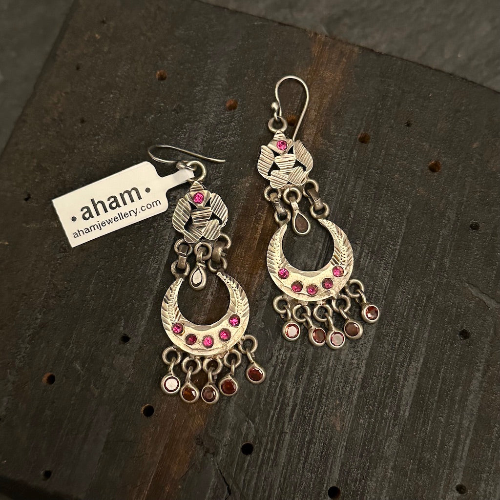 Tribal earrings created in silver with traditional artistry and craftsmanship.