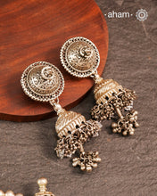 Elevate your festive look with this striking Tribal Silver Jhumkie, featuring bold, layered ghungroos that create a captivating sound and movement. Expertly crafted in silver, this statement earring complements all ethnic wear, making it perfect for Navratri and other celebrations. Its impressive size and intricate design add a traditional yet contemporary touch to your ensemble.