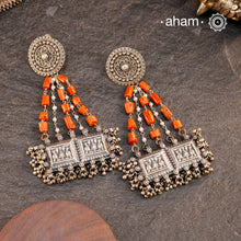 Large statement Chandelier earrings crafted in silver. Inspired from tribal forms, we have added turquoise and pearls to create drama to the whole piece. The fine rawa work and multiple ghungroos at the bottom add charm to the piece.