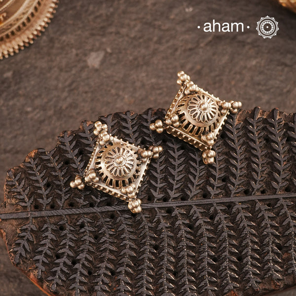 Crafted in silver with a unique jali-like pattern and rava highlights, these Tribal Silver Studs combine traditional tribal inspiration with modern elegance. Perfect for adding a touch of culture to any outfit.