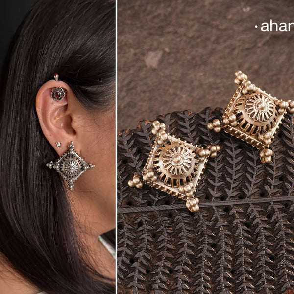 Crafted in silver with a unique jali-like pattern and rava highlights, these Tribal Silver Studs combine traditional tribal inspiration with modern elegance. Perfect for adding a touch of culture to any outfit.