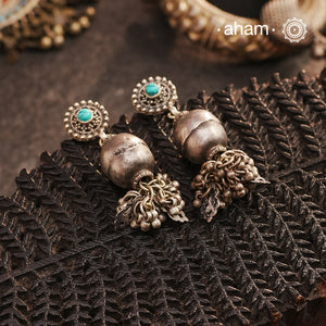 These Tribal Silver Earrings feature a vintage tribal bead adorned with mini ghungroos for added detail. The craftsmanship and blue stud add a touch of tradition and uniqueness to these earrings. Perfect for those who appreciate a distinct and traditional design.