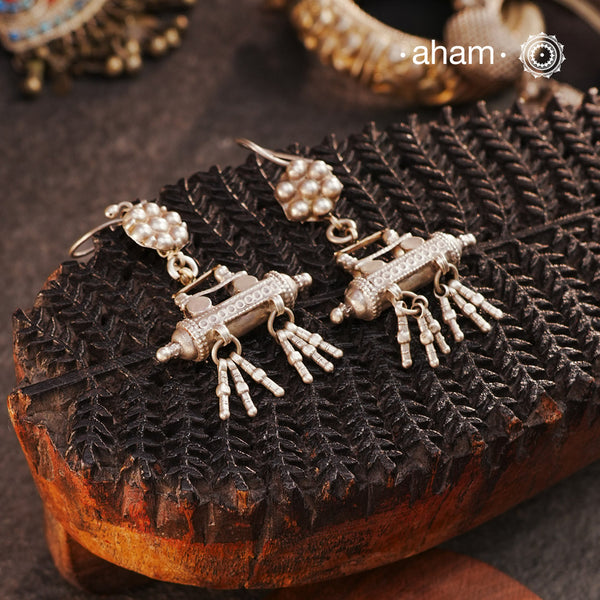 Crafted from carefully sourced tribal elements, our Tribal Amulet Silver Earrings feature a delicate flower top paired with an amulet drop adorned with hanging beads. A reflection of tribal heritage and intricate artistry, these silver earrings offer a bold yet elegant statement for those who love authentic tribal jewellery.