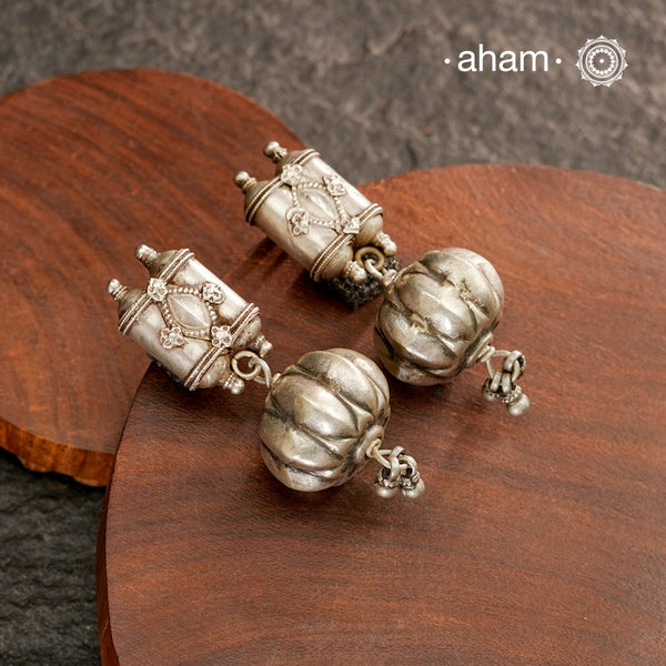 An exquisite fusion of the past and present, these Vintage Tribal Earrings unite two stunning silver pieces. The top features vintage amulets steeped in history, while the bottom showcases a beautiful bead. Handcrafted in silver, this unique piece is a must-have for those who cherish tribal heritage jewellery with a story to tell.