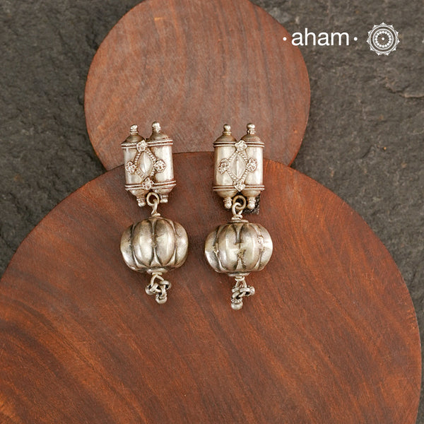 An exquisite fusion of the past and present, these Vintage Tribal Earrings unite two stunning silver pieces. The top features vintage amulets steeped in history, while the bottom showcases a beautiful bead. Handcrafted in silver, this unique piece is a must-have for those who cherish tribal heritage jewellery with a story to tell.