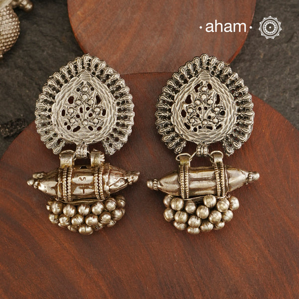 An exquisite fusion of the past and present, these Vintage Tribal Earrings unite two beautiful silver pieces. The top features an intricate leaf pattern stud while the bottom showcases a vintage amulet, steeped in history. Handcrafted in silver, this unique piece is a must-have for those who cherish tribal heritage jewellery with a story to tell.